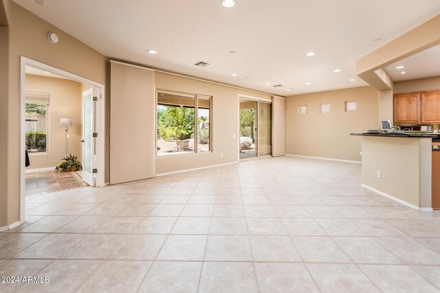 unfurnished living room with light tile patterned floors