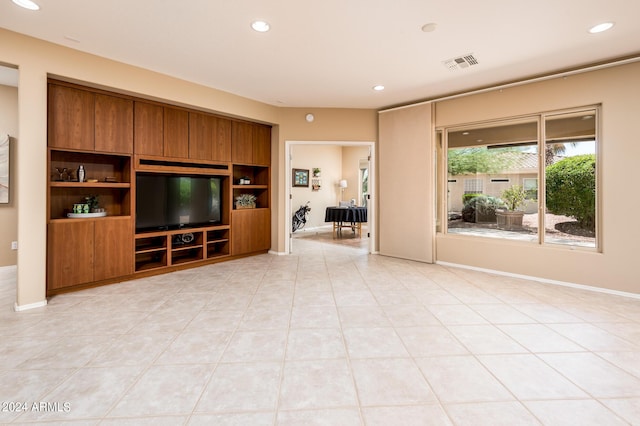 unfurnished living room with light tile patterned floors