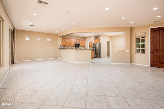 unfurnished living room featuring light tile patterned floors