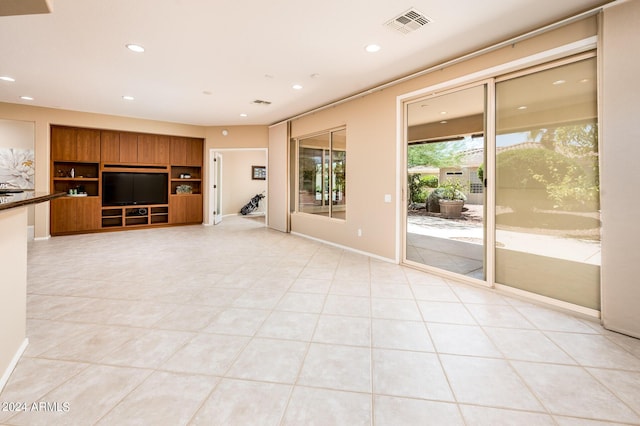 unfurnished living room with light tile patterned floors