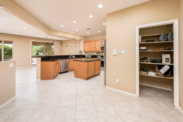 kitchen with light tile patterned flooring, sink, a center island, kitchen peninsula, and stainless steel appliances