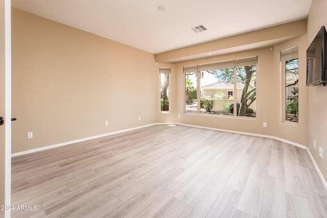 unfurnished room with light wood-type flooring