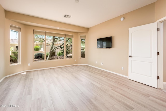 unfurnished room with light wood-type flooring