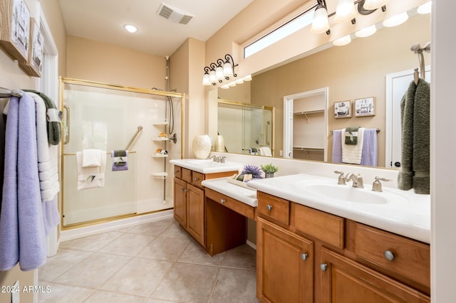 bathroom with walk in shower, tile patterned floors, and vanity