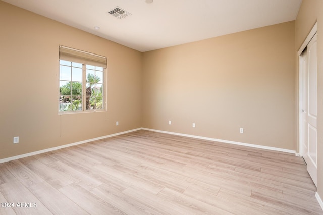 unfurnished bedroom featuring a closet and light hardwood / wood-style flooring