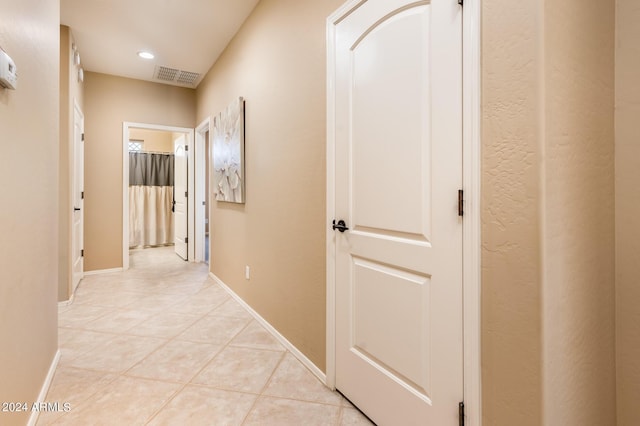 corridor with light tile patterned flooring