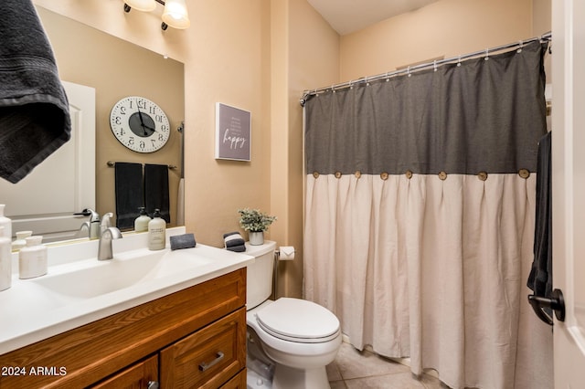 bathroom with tile patterned flooring, vanity, and toilet