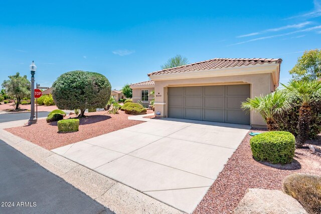 mediterranean / spanish home with a garage