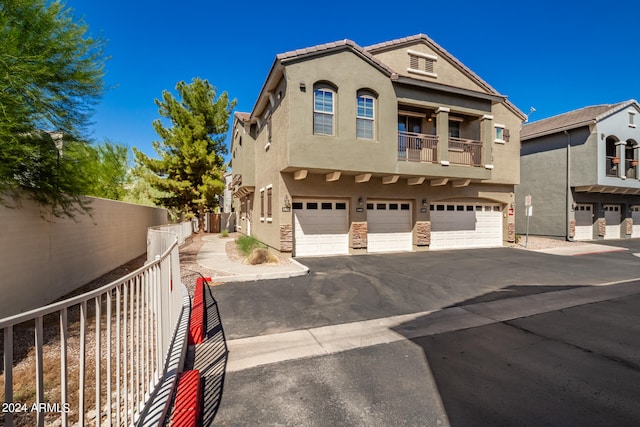 view of front of house with a balcony and a garage