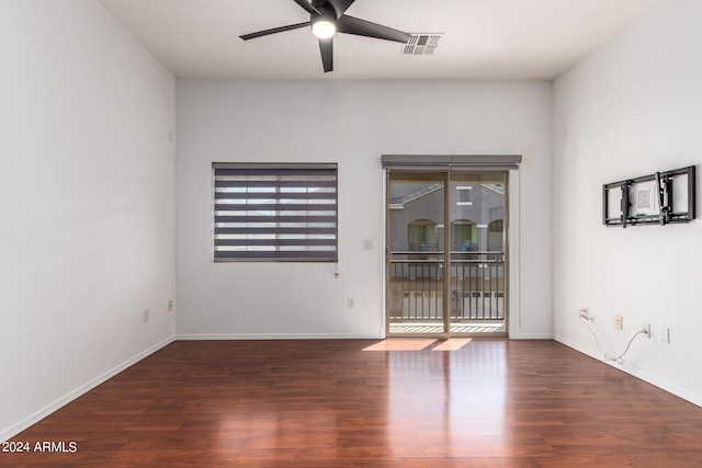 empty room with ceiling fan and dark hardwood / wood-style floors