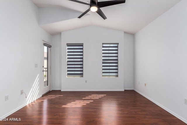 spare room with vaulted ceiling, ceiling fan, and dark wood-type flooring