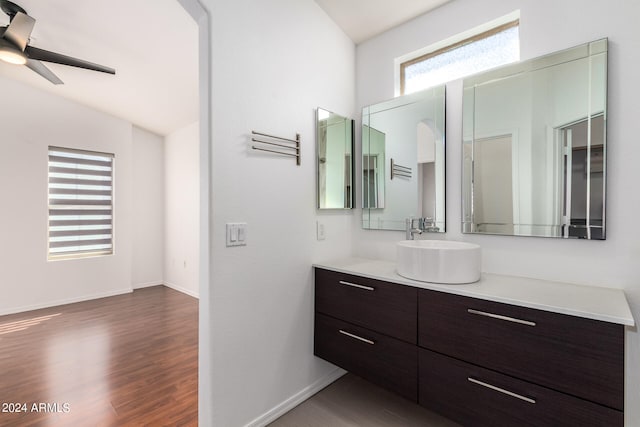 bathroom with lofted ceiling, vanity, hardwood / wood-style floors, and ceiling fan