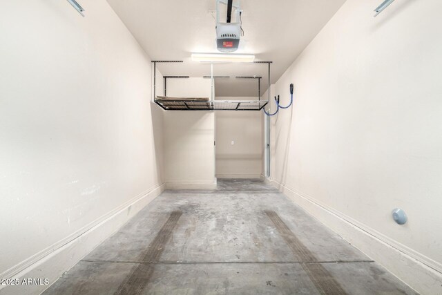 garage featuring a garage door opener and baseboards