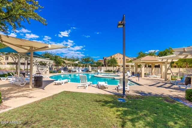 community pool featuring a yard, a pergola, fence, and a patio area
