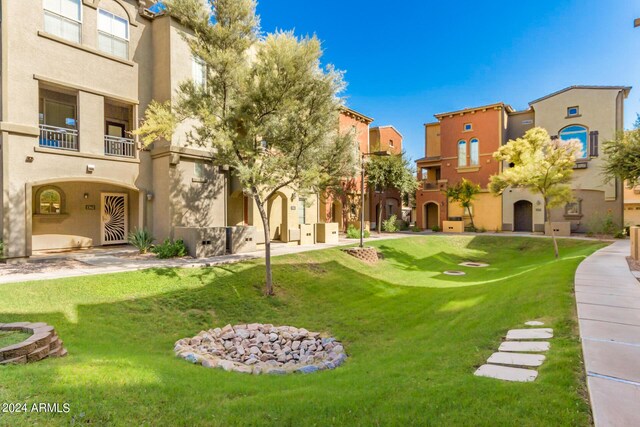 view of property's community with a residential view and a yard