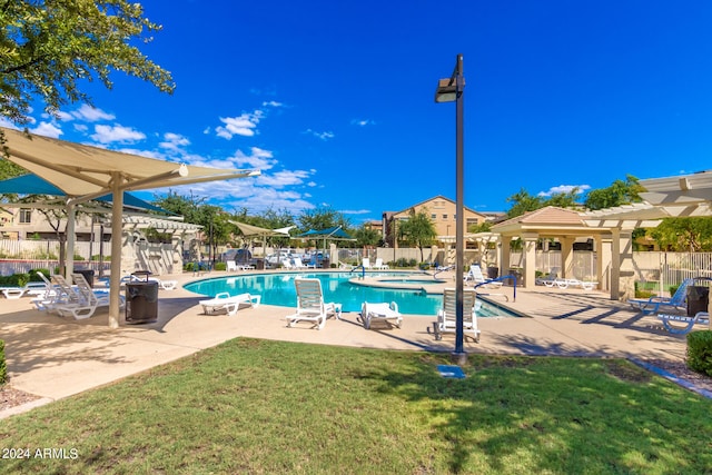 view of swimming pool featuring a patio area and a yard