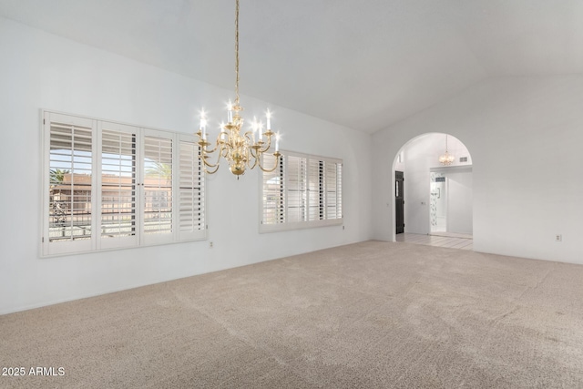 unfurnished room with light carpet, a chandelier, and lofted ceiling