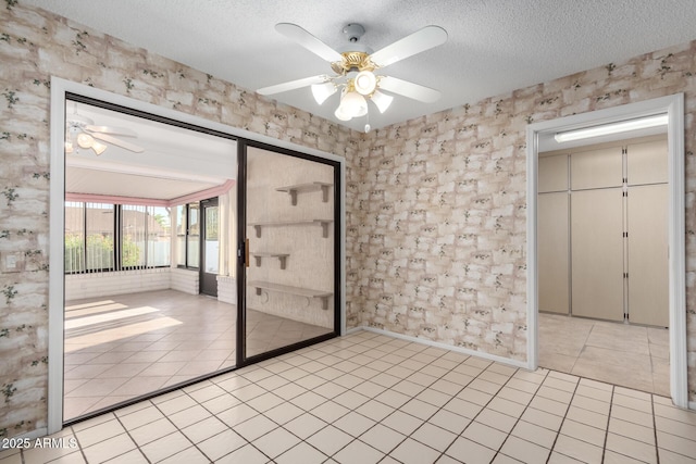 unfurnished bedroom with light tile patterned flooring, a textured ceiling, and a closet