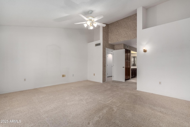 unfurnished room featuring ceiling fan, high vaulted ceiling, and light colored carpet