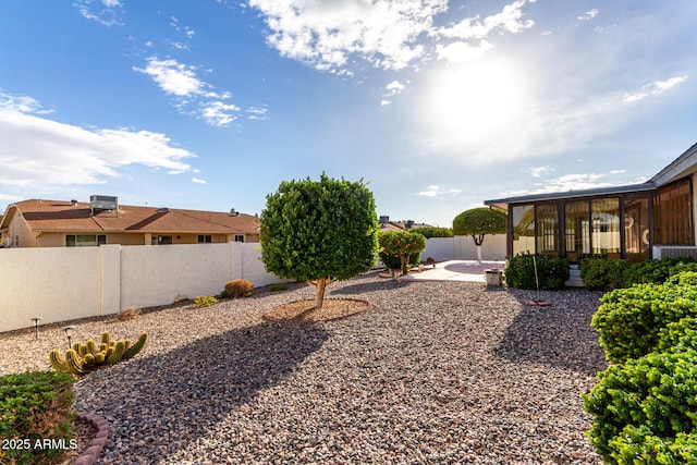 view of yard with a patio, central AC unit, and a sunroom