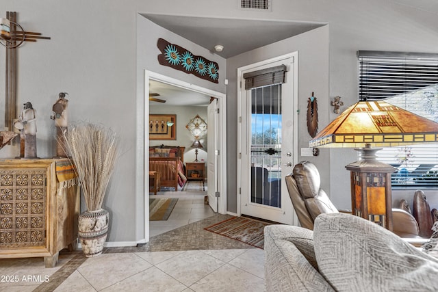 interior space featuring ceiling fan and light tile patterned floors