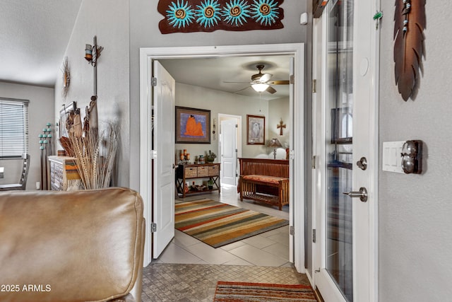 foyer with tile patterned floors and ceiling fan