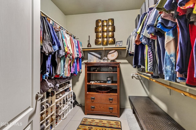 spacious closet with light tile patterned floors