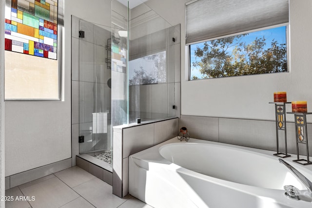 bathroom with tile patterned floors and independent shower and bath