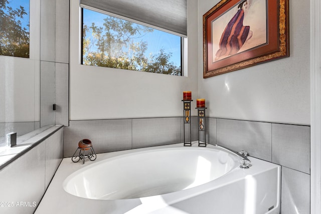 bathroom with a tub to relax in