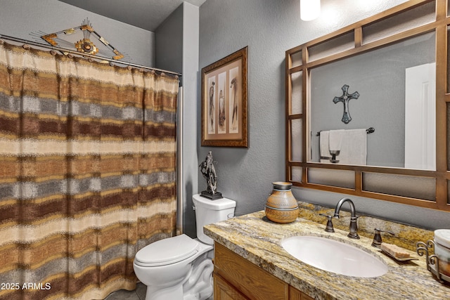 bathroom featuring vanity, toilet, and walk in shower