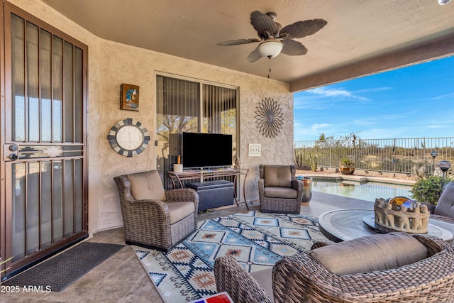 view of patio with a fenced in pool and ceiling fan