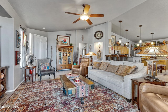 living room with ceiling fan and vaulted ceiling