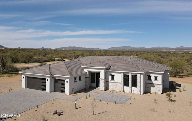 view of front of home with a mountain view and a garage