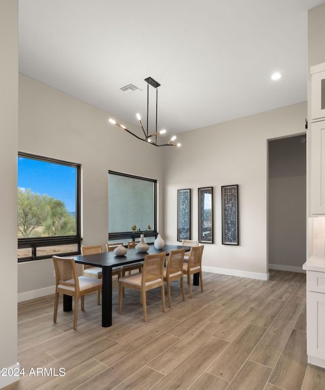 dining room with baseboards, visible vents, an inviting chandelier, light wood-type flooring, and recessed lighting