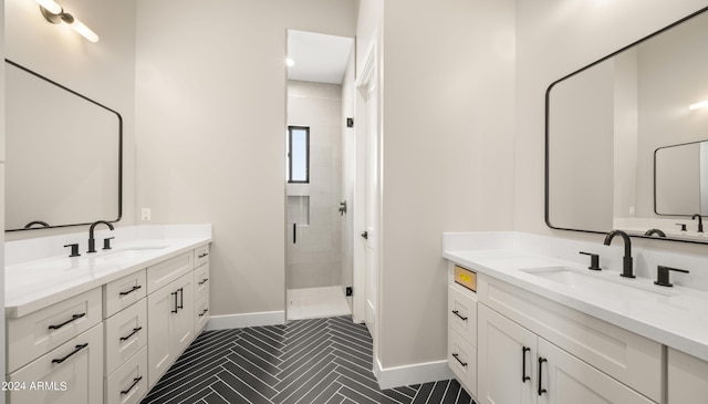 bathroom featuring two vanities, a sink, a shower stall, and baseboards