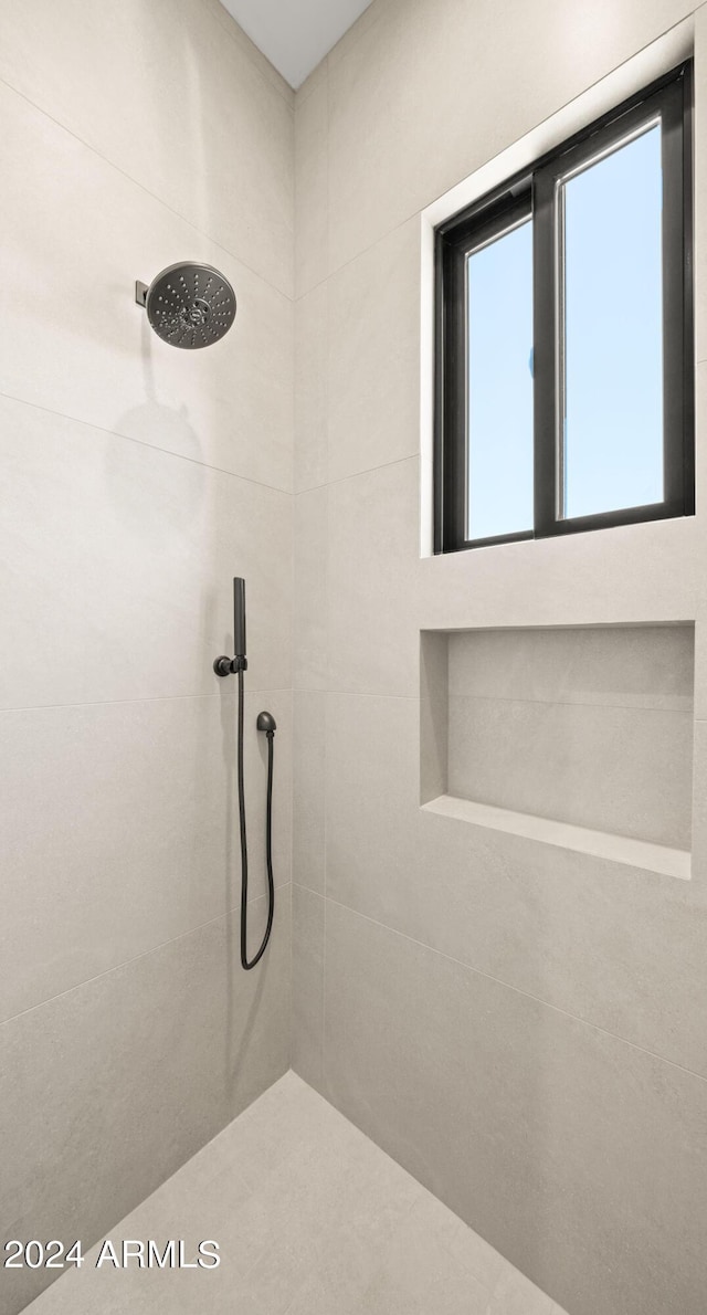 full bath featuring tiled shower