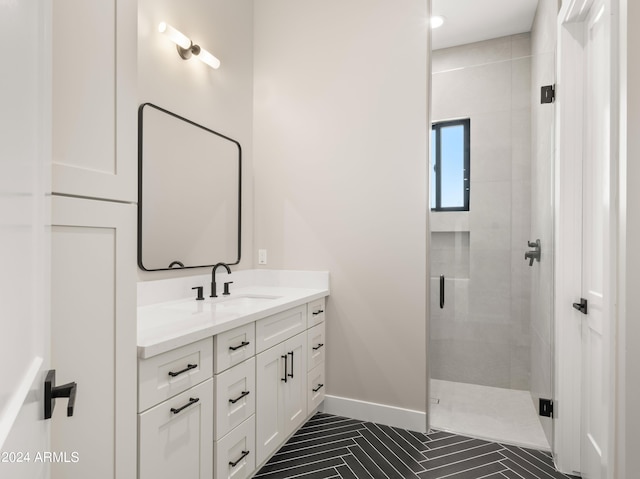 bathroom with a shower stall, vanity, and baseboards