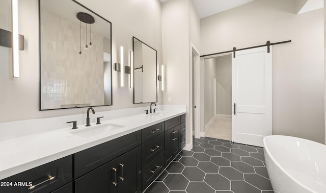 bathroom featuring double vanity, a soaking tub, tile patterned flooring, and a sink