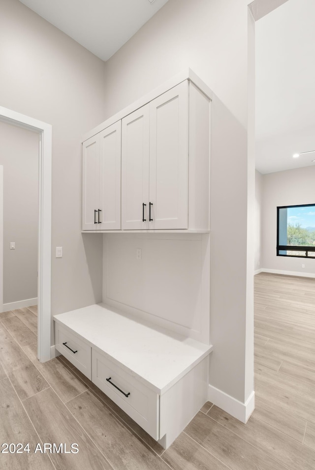 mudroom with light wood-type flooring and baseboards