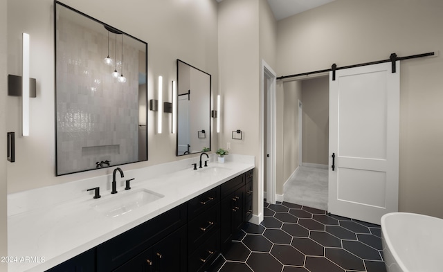 full bath featuring a freestanding bath, double vanity, and a sink