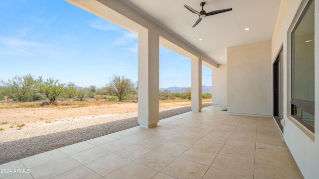 view of patio featuring a mountain view and a ceiling fan