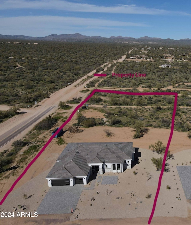 birds eye view of property with a mountain view