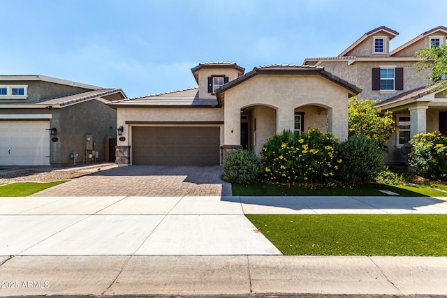 2716 S Chatsworth, Mesa, AZ 85209 - view of front of home with driveway, a garage, stucco siding, stone siding, and a tiled roof