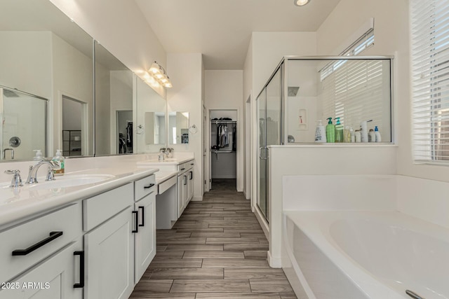 2716 S Chatsworth, Mesa, AZ 85209 - bathroom featuring a bath, a shower stall, double vanity, wood finished floors, and a spacious closet