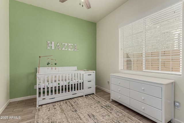 2716 S Chatsworth, Mesa, AZ 85209 - bedroom featuring wood finished floors, a crib, and ceiling fan
