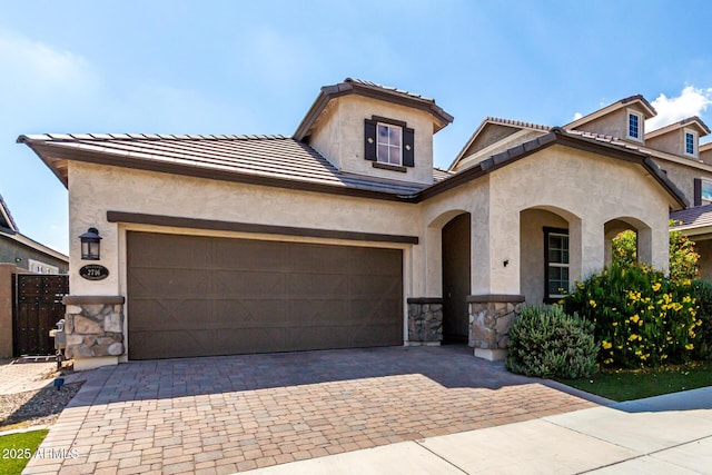 2716 S Chatsworth, Mesa, AZ 85209 - view of front of property featuring stone siding, decorative driveway, stucco siding, a garage, and a tiled roof
