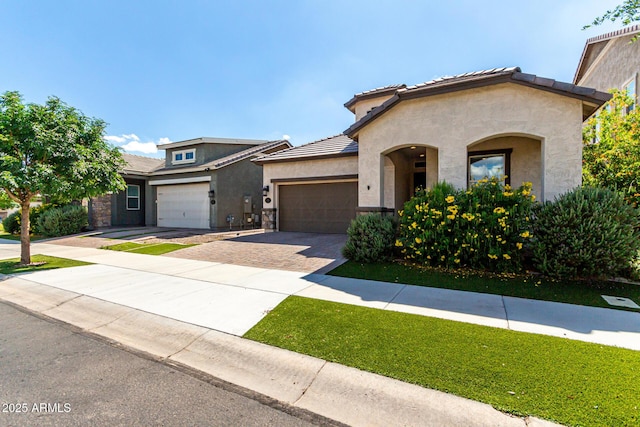 2716 S Chatsworth, Mesa, AZ 85209 - mediterranean / spanish-style house featuring stucco siding, driveway, a garage, a tiled roof, and stone siding