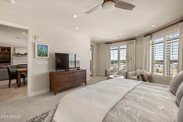 bedroom featuring light colored carpet and ceiling fan