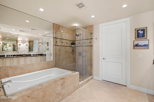 bathroom with separate shower and tub, tile floors, and large vanity