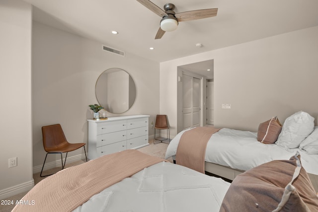 bedroom featuring light carpet and ceiling fan